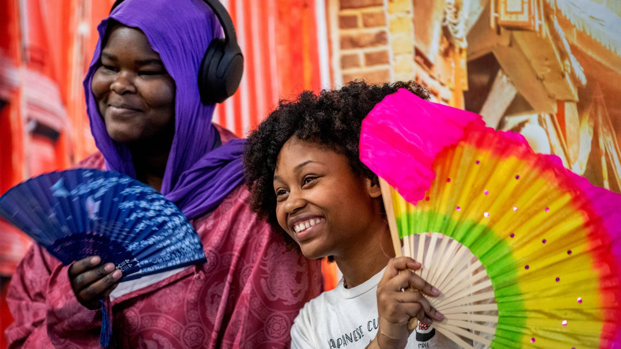 Students holding multicolored fans at Global Language & Culture Festival